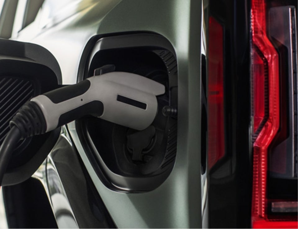 Close up of charging port with charger plugged in on a GMC Hummer EV SUV - Wackerli Auto Center in Idaho Falls ID