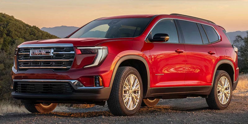 Red 2026 GMC Acadia SUV parked outdoors.