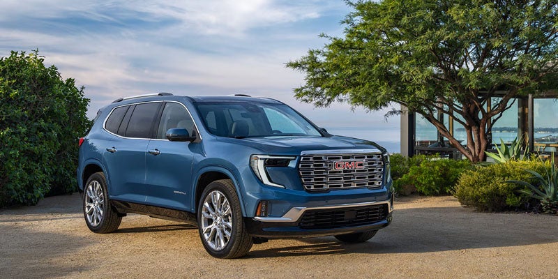 Blue 2026 GMC Acadia SUV near coast.