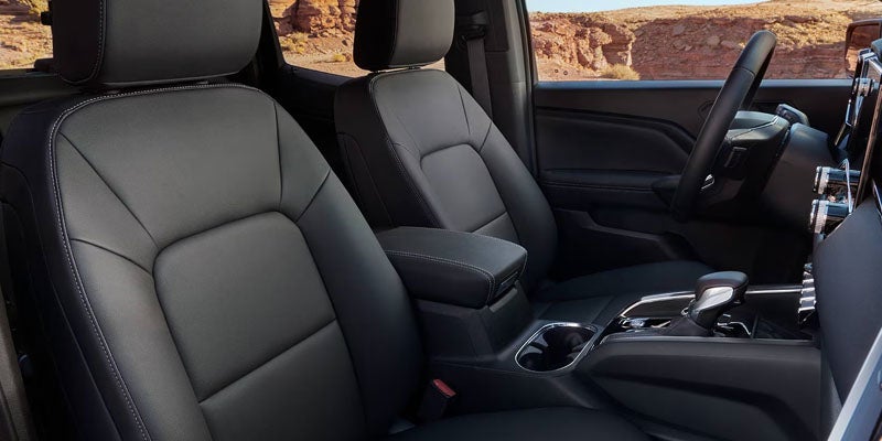 Black leather front seats of a 2026 GMC Canyon.